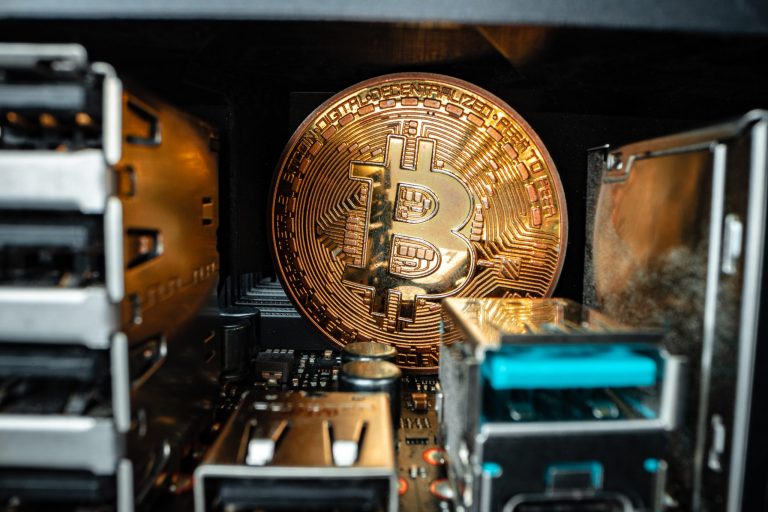 A glowing Bitcoin logo surrounded by digital binary code, symbolizing the rise of cryptocurrency and blockchain technology.