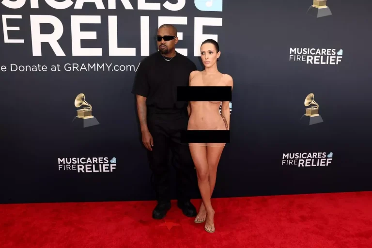 Bianca Censori at the 2025 Grammy Awards in a sheer slip dress beside Kanye West.