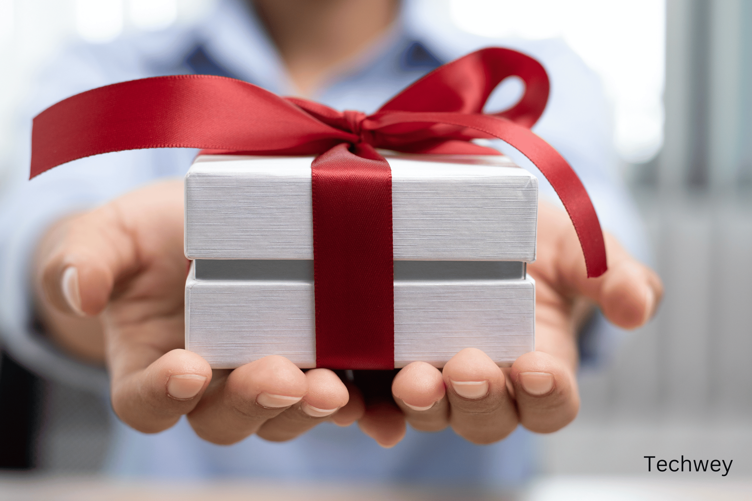 tech gifts. A man holding a gift box
