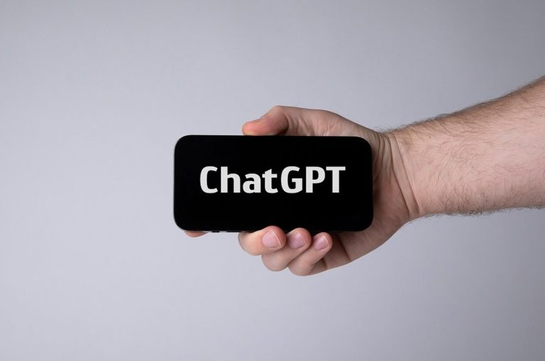Hand holding smartphone with ChatGPT